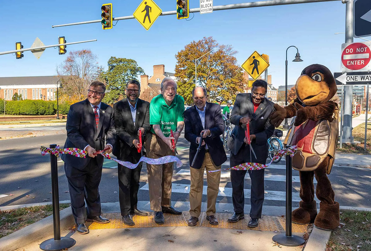 People and the Testudo Mascot cutting a ribbon.