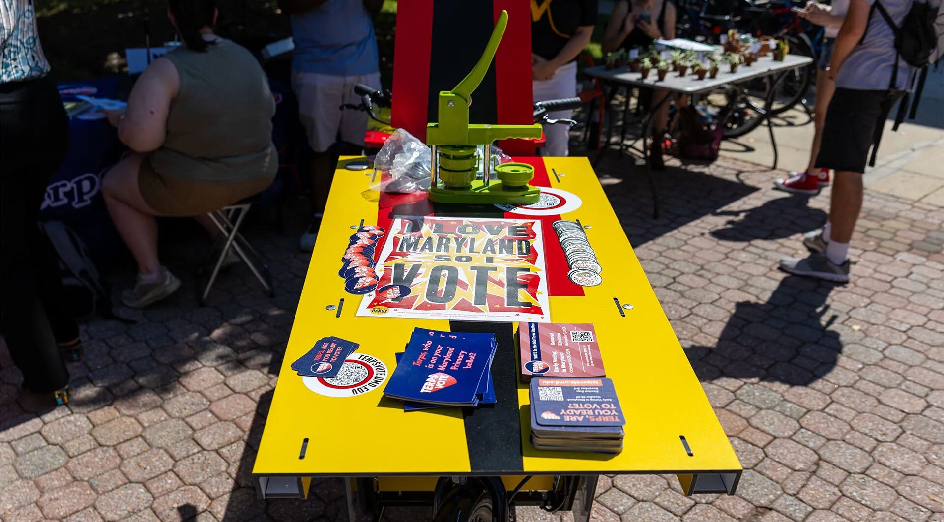 TerpsVote bicycle showcasing a poster, flyers and a button maker