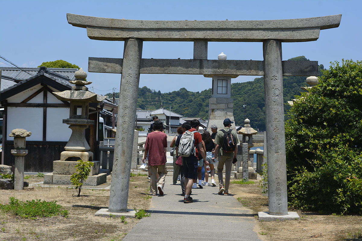 Students walking through a Japanese gate