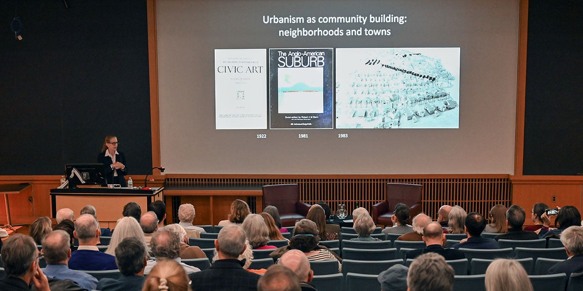 People sitting in an auditorium attending a lecture