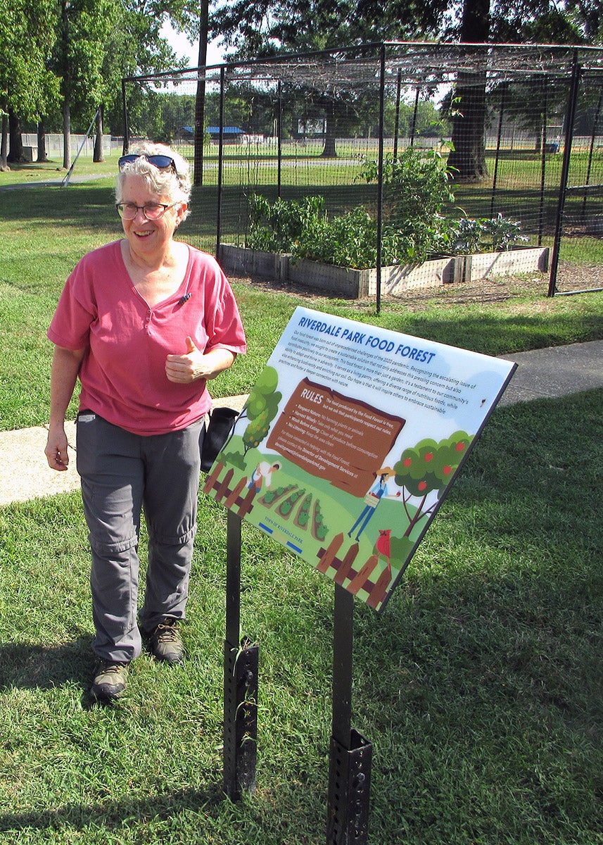 Lora Katz next to a Riverdale food forest