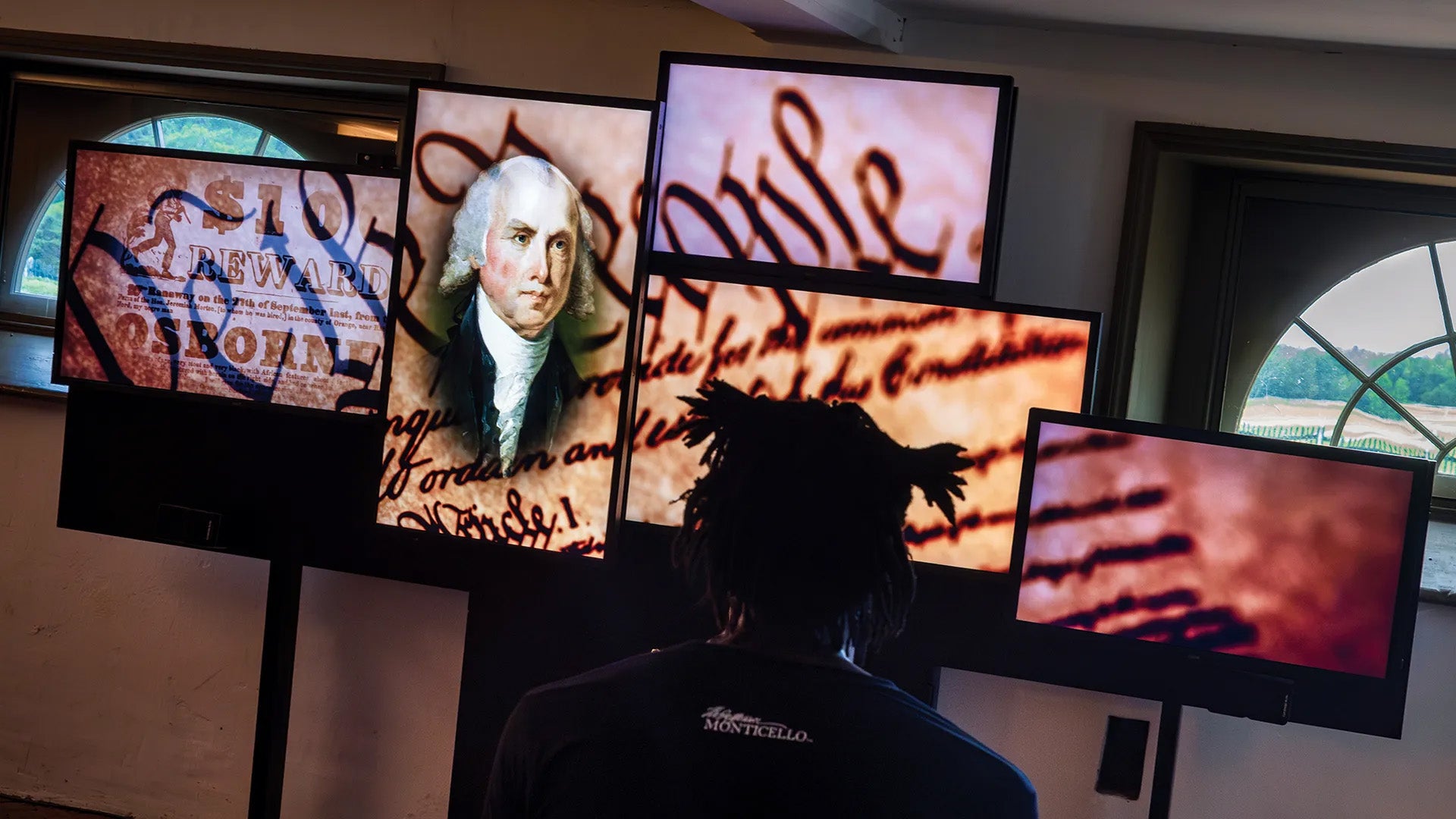 Multiple screens showcasing James Madison on the Constitution as part of an exhibit