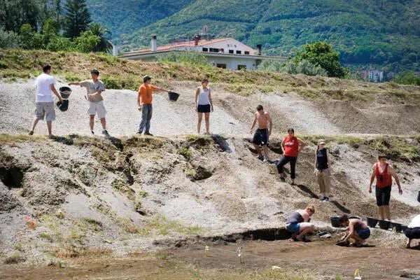 Row of students passing along buckets of soil
