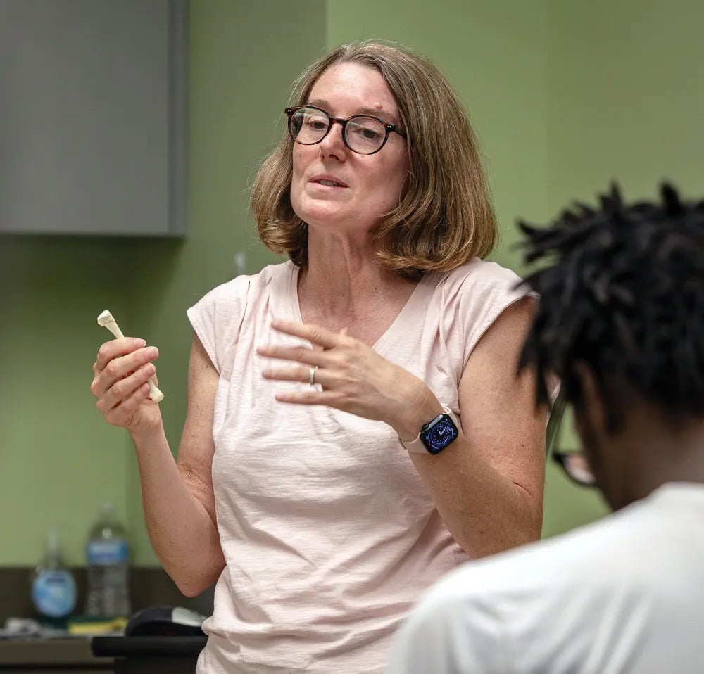 Professor Barnet Pavão-Zuckerman holding an animal bone