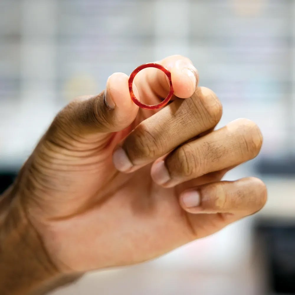 A red carnelian ring in someones hand