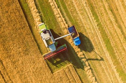 Aerial shots of tractors working on an agriculture field