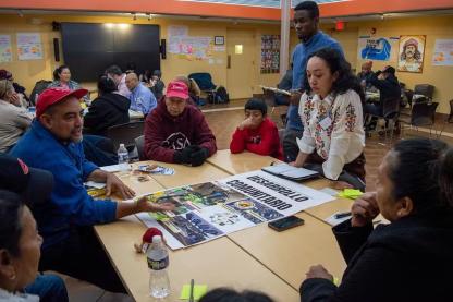 Students and Langley Park residers going over a community plan