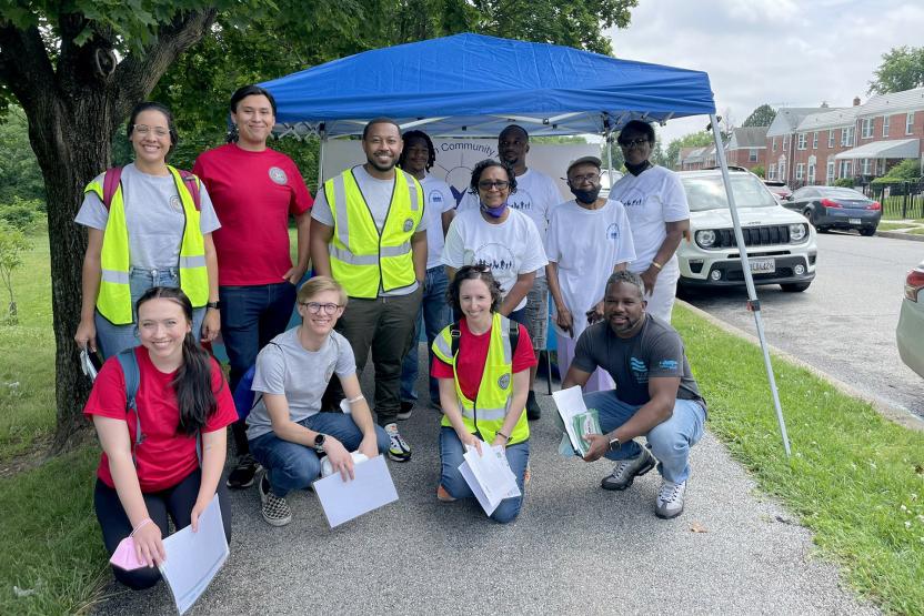 Group photo of the WET team and community wearing safety vests