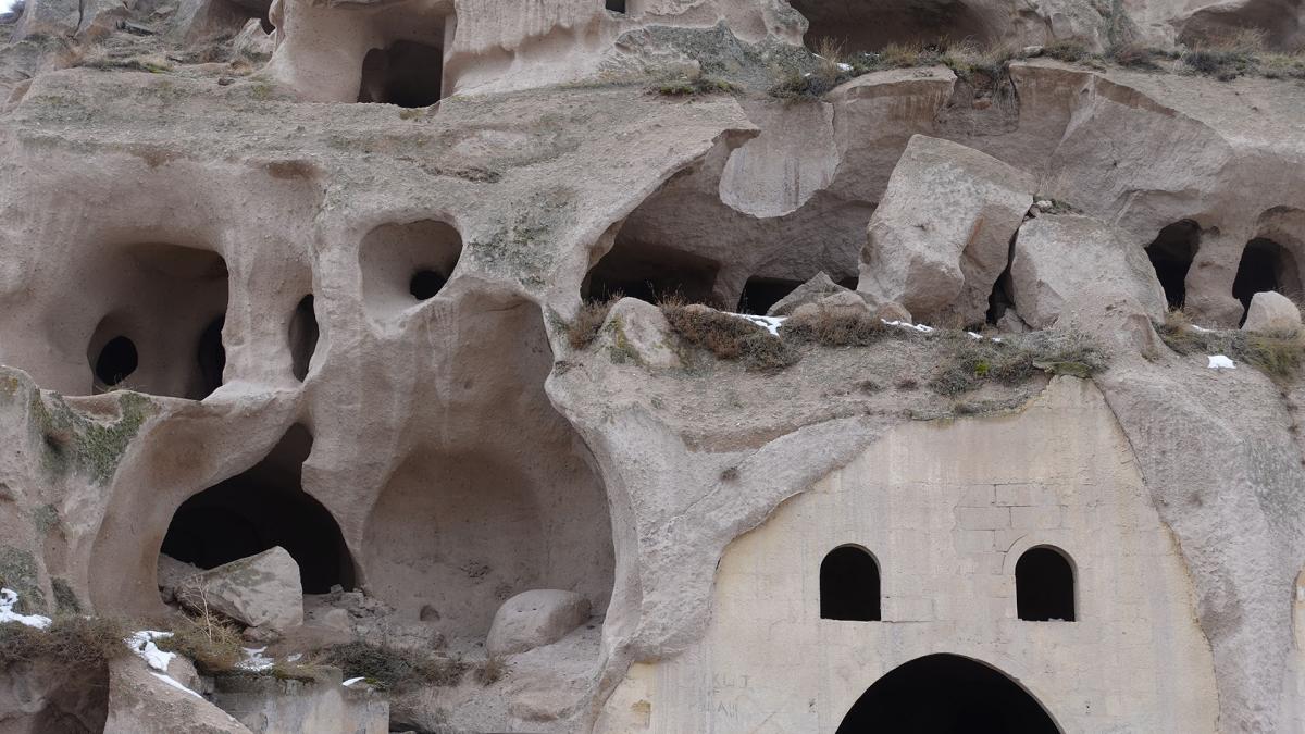 Natural and man made caves in a cliff