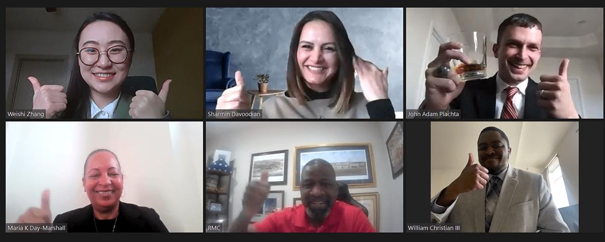 A screenshot of a virtual meeting shows seven people in separate video boxes, all smiling and giving thumbs-up gestures.
