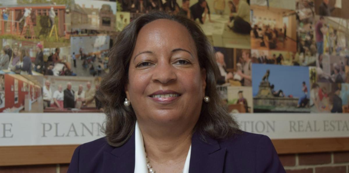 A lady in business attire smiling for a photo. 
