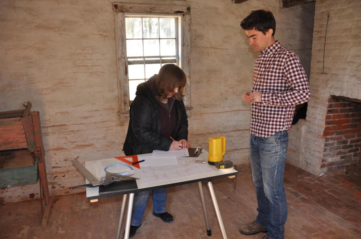A man and women collaborating on a project 