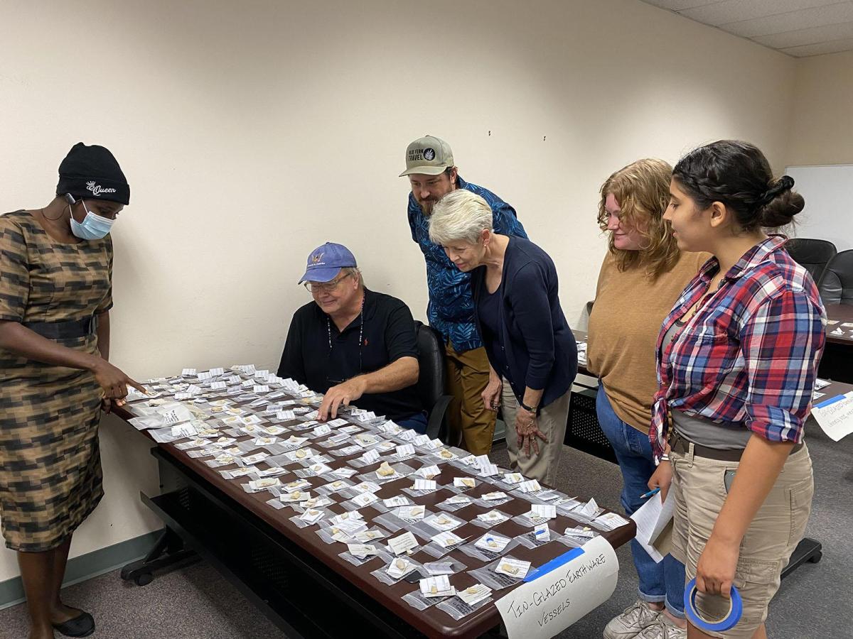Ceramic experts and students looking at various artifacts