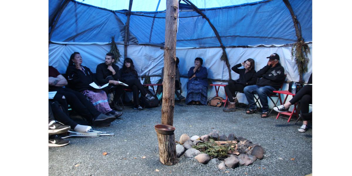 People gathered in a large tent