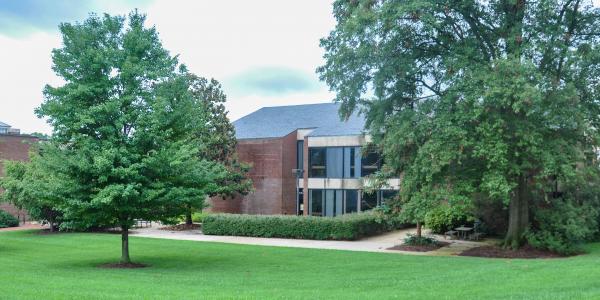 Outside Architecture building, green grass and patio area