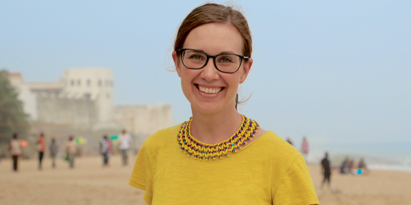Emily Williamson Ibrahim in yellow shirt and beach background