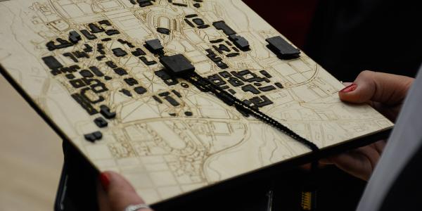 Graduation cap with a laser cut map and buildings