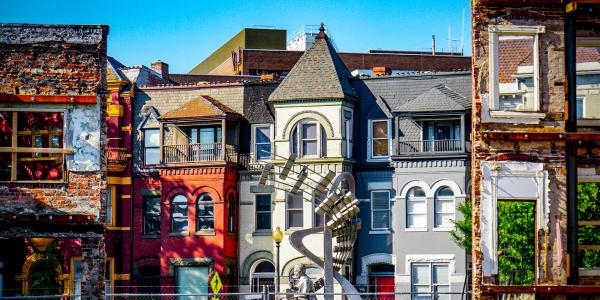 Row houses, some redeveloped and others worn down.