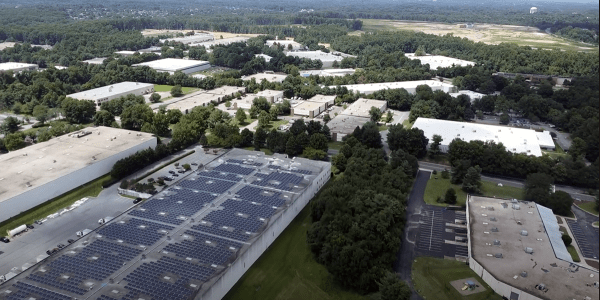 Aerial shot of solar panels in green suburban area