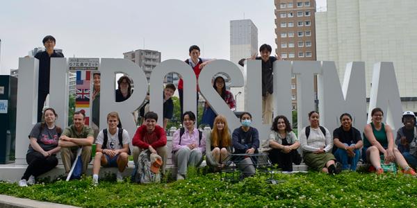 Students in front of a Hiroshima sign