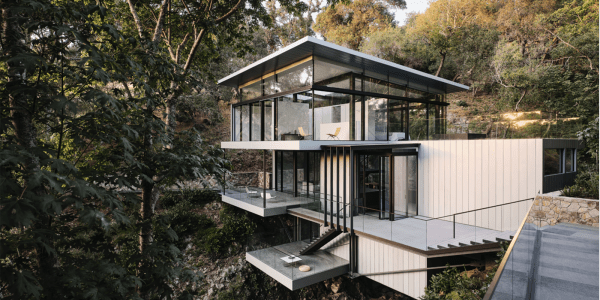 A house suspended on rocks in a forest landscape