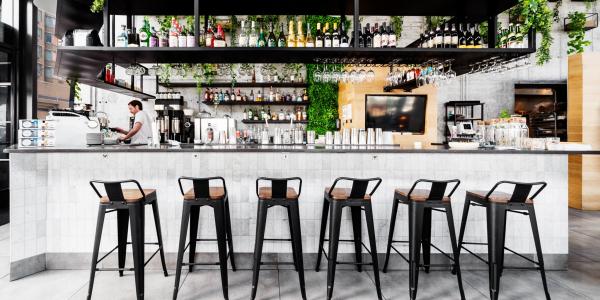 A bar with high table chairs