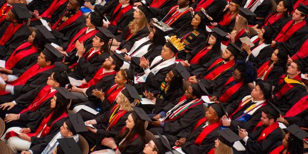 A view from above of students in their regalia and caps