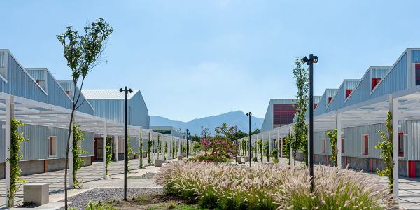 Library with a courtyard in the middle and mountains in the background.