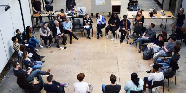 Students sitting in a circle in chairs