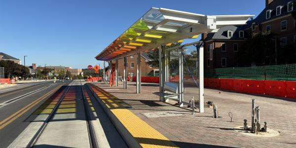 Purple Line train stop with a colorful canopy