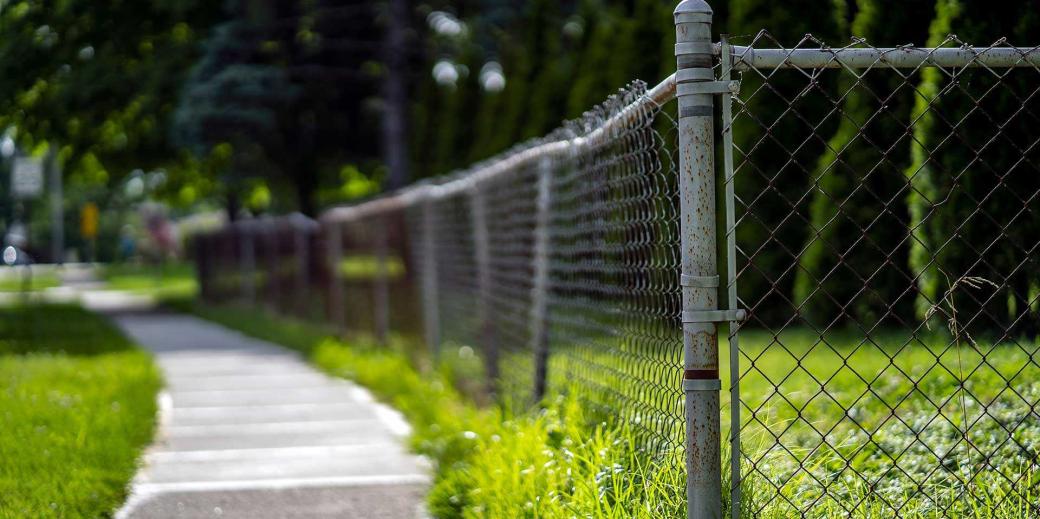 Chain-link fence in a green neighborhood