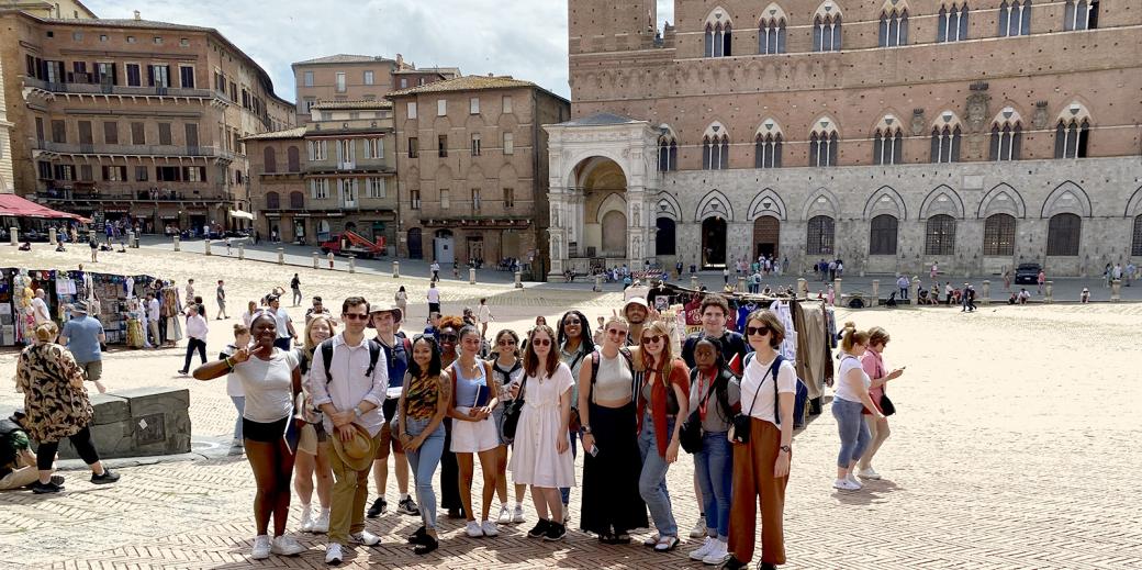 Students posing in a plaza in Sienna, Italy