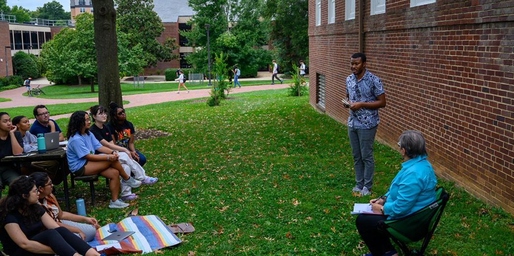 Michel Cabral Mandela Fellow speaking to students outside