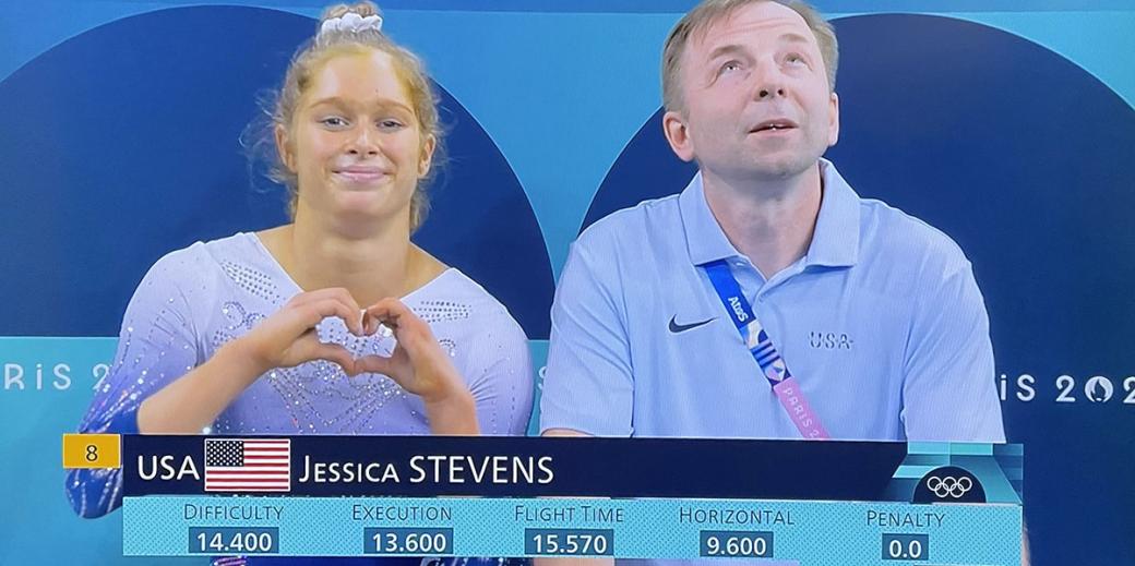 Olympic athlete and TERP alumn holding a heart hand gesture