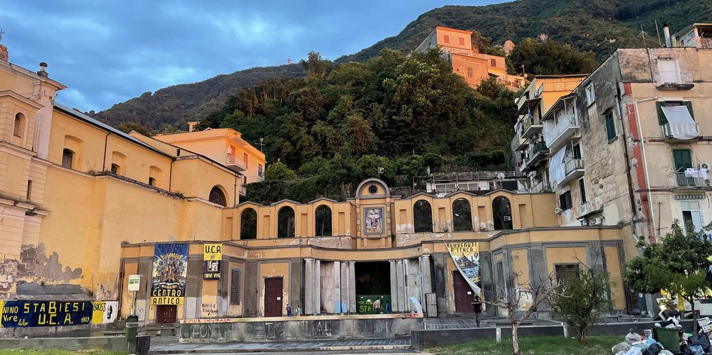 Historic buildings on a hill in Stabiae, Italy. Sunset colors are illuminating the facade.