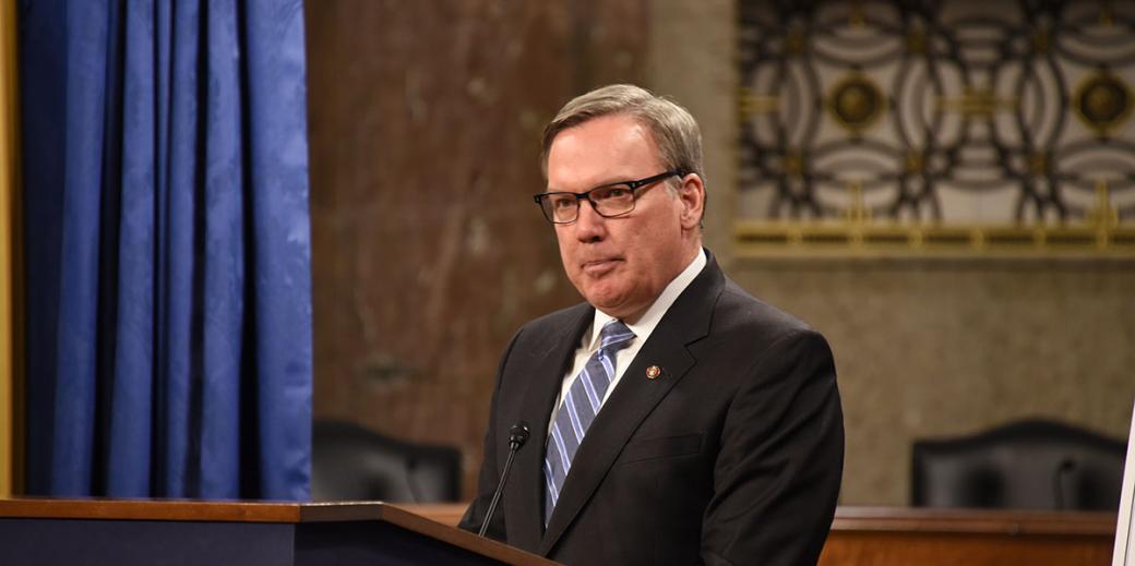 Stephen Ayers speaking at a podium