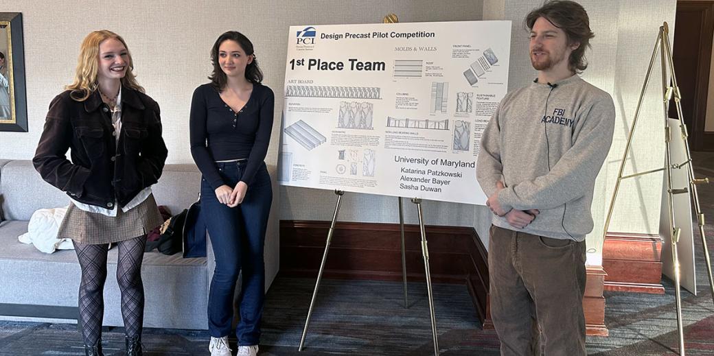 Students standing in front of a poster board - 1st place winners
