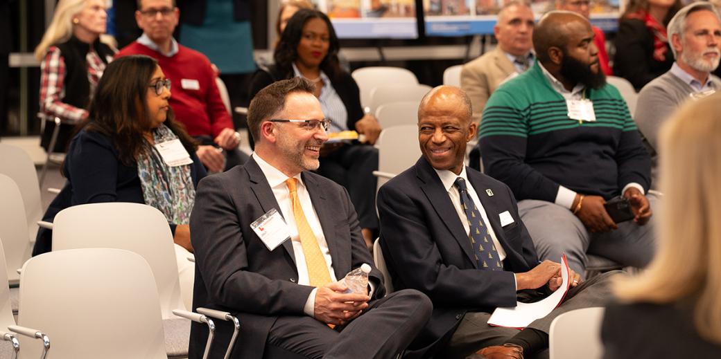 Jason Sartori and Artie Harris smiling in a crowd.