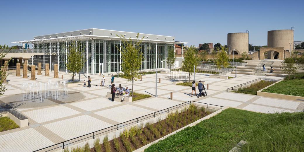 Exterior of the community center with cisterns in the background.