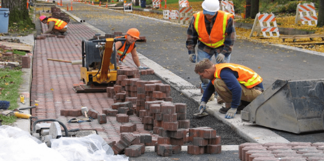 Construction workers laying bricks