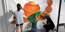 Students painting oranges
