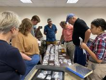 Students and faculty gathered around Kippax artifacts