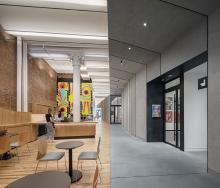 Split image of the interior of a building with a colorful mural, brick wall and wooden floor versus a concrete grey and black interior.