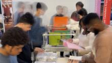 Slow shutter of people looking through magazines