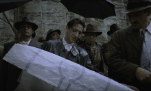 A man holding an architectural plan
