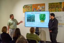 Students presenting their architecture project on sustainably harvesting and repurposing bamboo.