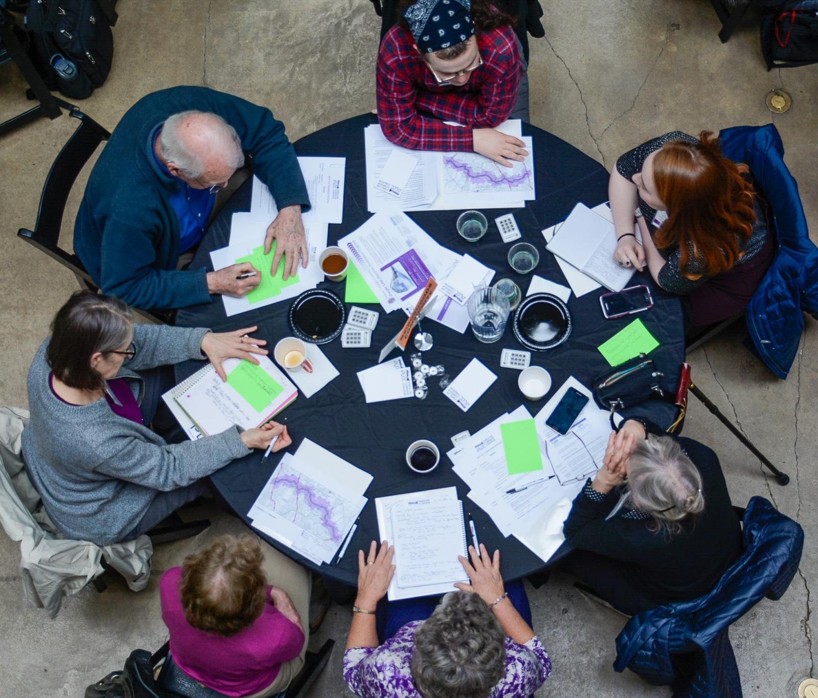 View from above of people at a table during the National Center for Smart Growth (NCSG), Purple Line Corridor Coalition (PLCC) event in March 2019.