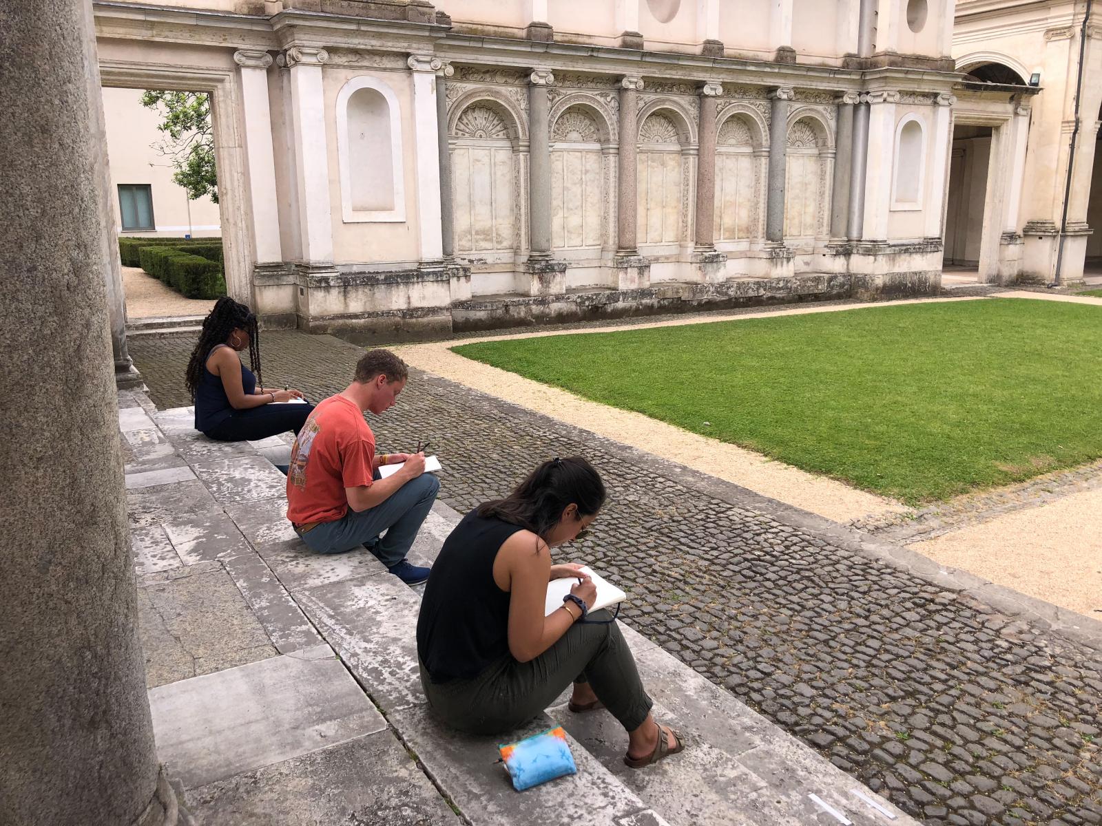 Students sketching on the steps of Villa Giulia in Rome, Italy