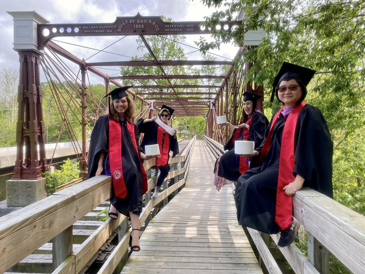 Spring 2020 HISP Graduates on a Bridge holding toilet paper