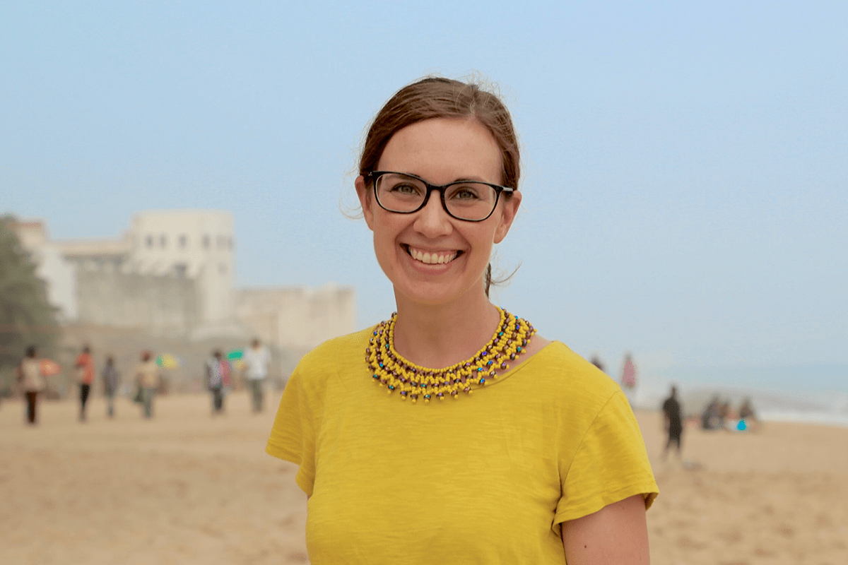 Emily Williamson Ibrahim in yellow shirt and beach background